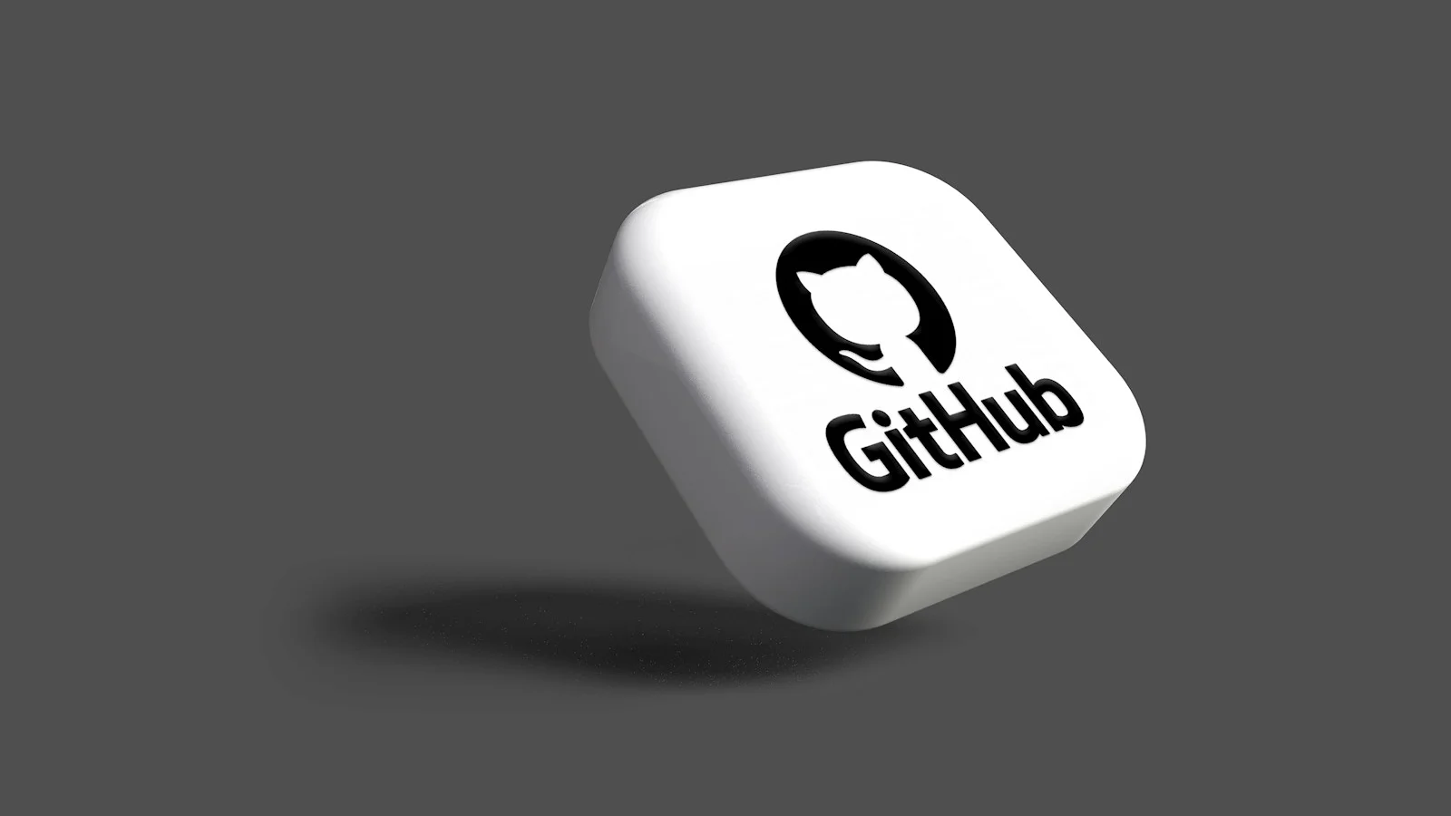 a white dice with a black github logo on it